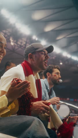 Vertical Screen. Sport Stadium Fans. Close-up of a Joyful Supporters Cheering a Soccer Championship, Waving Red and White Scarves as Confetti Falls at an International League Match.