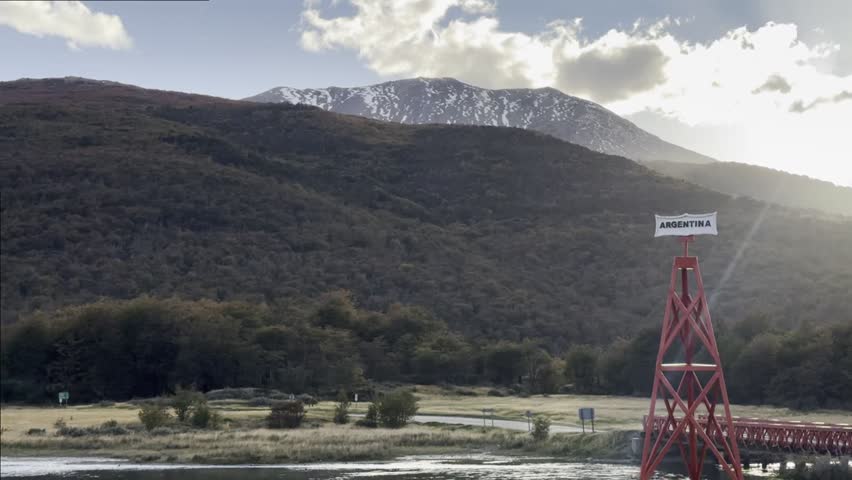 Landmark of Argentine territory, backdrop of autumn mountains. Tierra del Fuego National Park, Ushuaia, Tierra del Fuego.