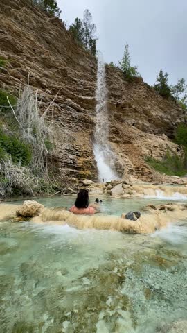 Woman relaxing in Fairmont Hot Springs natural pools in Canada