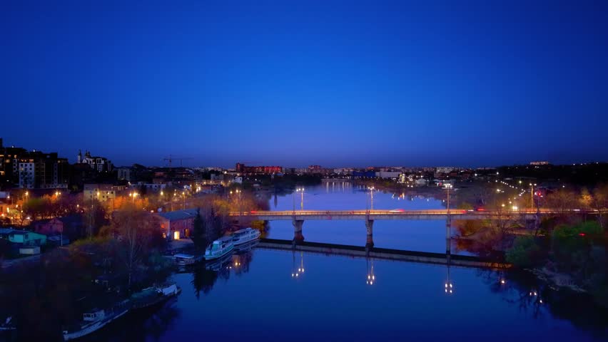 Cinematic Nighttime Bridge over River with Light Trails