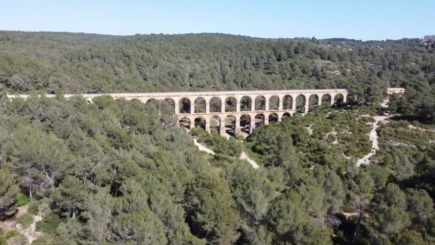 Drone Approaching Roman Aqueduct in Tarragona, Spain, Ancient Architecture, Daylight