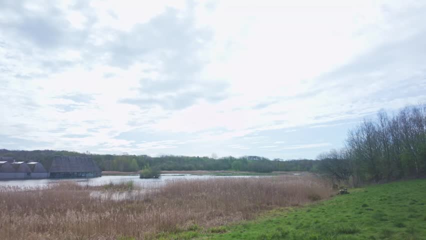 A wide, cinematic pan across the wetlands of Brockholes Nature Reserve, featuring the unique floating visitor centre and lush reed beds. This clip includes authentic natural audio of local birdsong, offering an immersive experience of the Lancashire countryside and sustainable eco-tourism.