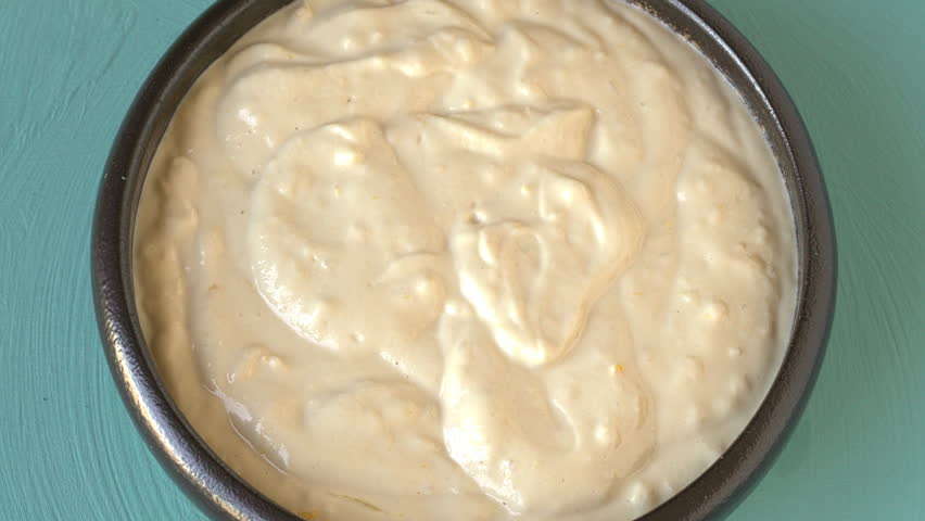 Middle Eastern tahini dip with garlic and lemon - tasty and healthy vegan condiment.