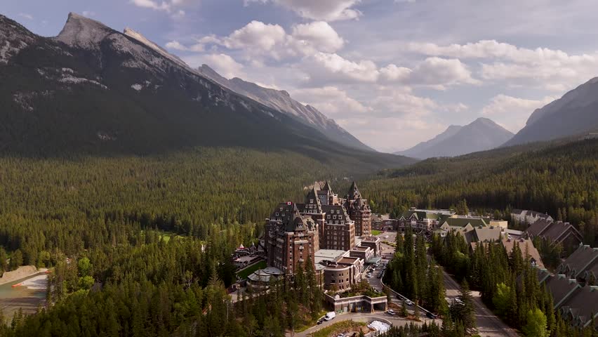 Cinematic drone footage of the historic Fairmont Banff Springs Hotel with majestic Mount Ruddle in the background, Banff National Park, Alberta. Road trip in Canada. Rocky mountains. 4k footage