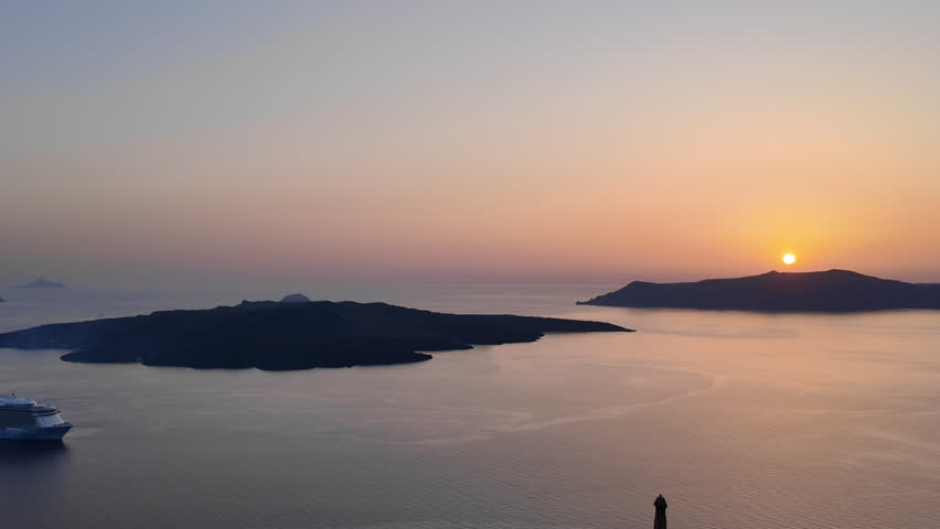 Breathtaking sunset view of the famous caldera and the volcano of Santorini Greece