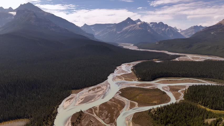 Aerial view of braided riverbeds and brown scree slopes along the Icefields Parkway, showing low water levels between Banff and Jasper National Parks, Alberta. Road trip in Canada. Rocky mountains.