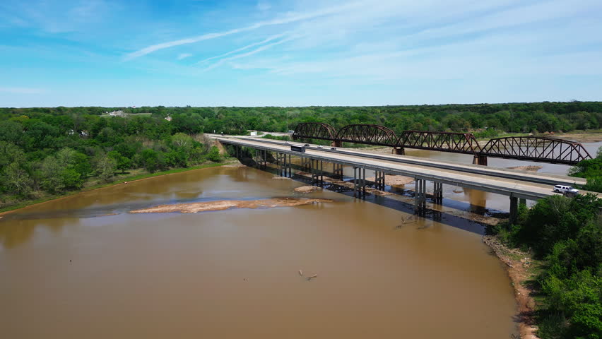 Aerial orbit of the Red River and bridges along the Texas Oklahoma border. 