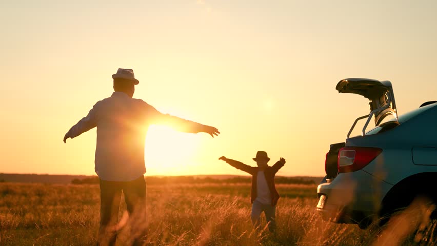 Happy family, father, child son travel, car. Happy father son spinning in sun sky, meadow. Dad spinning with kid son, holding hands. Cheerful people in park, parents with child. Family trip to nature