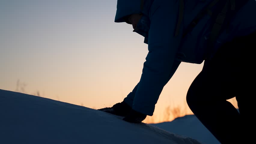 Business team victory. Lend helping hand, partner. Travelers climb mountain together. Climbers, holding hands, reach top of hill. Silhouettes. Business teamwork. Achieve your goal. Struggle for life