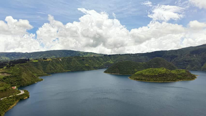 Cinematic Aerial View of Laguna Cuicocha with Cotacachi Volcano in Ecuador, Stunning drone footage of Laguna Cuicocha crater lake with Cotacachi volcano in the background captured in cinematic style showcasing Ecuador’s Andean landscape natural beauty