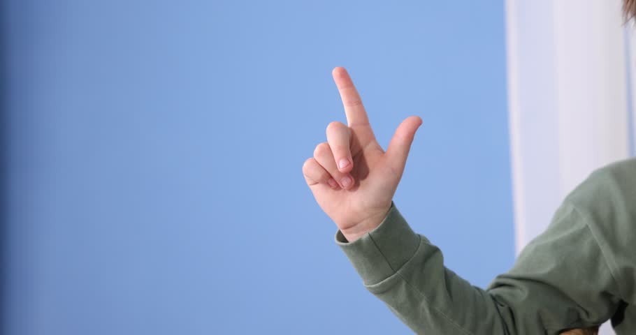 Little child showing gun gesture at home, closeup