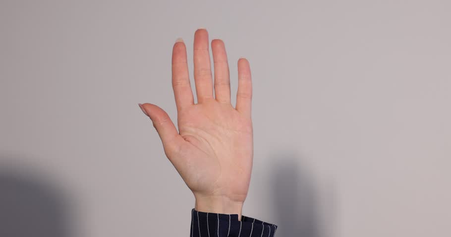 Woman showing signal for help on light grey background, closeup