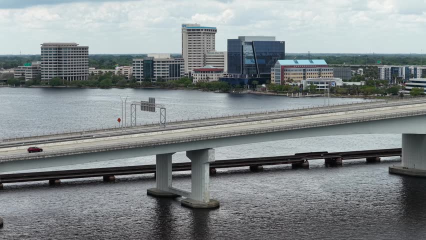 Aerial footage of cars driving over a bridge on the St Johns River in Jacksonville Florida USA