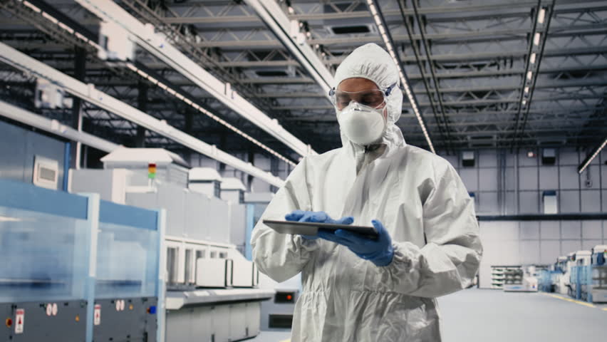Testing silicon wafer batches, tablet control app and portrait of expert in microchip factory. Monitoring semiconductor machinery, device readouts and engineer in manufacturing plant, camera B