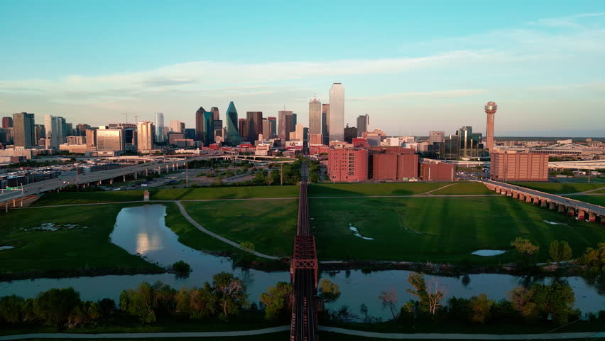 Dallas evening skyline with Trinity River and railroad track. 