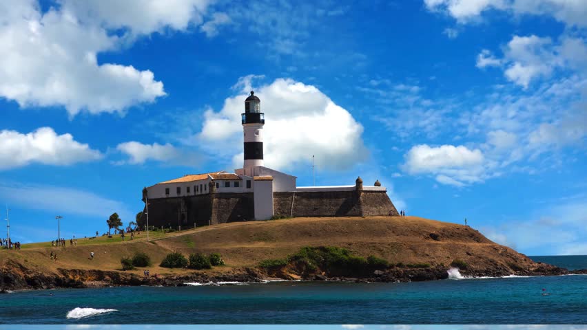 Sunset at the famous Farol da Barra in the city of Salvador, BahiaSalvador, Bahia, Brazil  -Sunset aerial view of tourism postal card at downtown Salvador Bahia Brazil. Barra Lighthouse at Brazilian Northeast. Tropical travel destination.