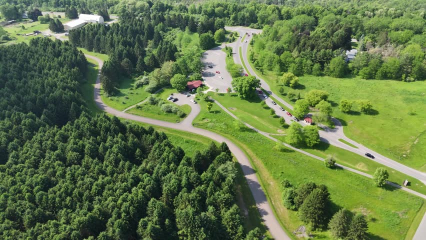 Trails, footpaths, driving lanes and forest cover this landscape of the exit and entryway of a state park.