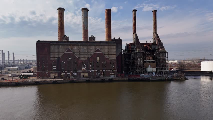 High-quality aerial drone footage of an abandoned power plant formerly operated by Public Service Electric and Gas Company in Kearny. This cinematic shot captures the decaying industrial structures, smokestacks, and surrounding urban landscape, highlighting themes of industrial decline, urban decay, and forgotten infrastructure.
Perfect for use in documentaries, news segments, environmental stories, historical retrospectives, or cinematic projects exploring energy, industry, abandonment, or post-industrial America. The footage offers a dramatic and atmospheric perspective from above, with strong visual storytelling potential.

Keywords: abandoned power plant, industrial ruins, urban decay, derelict factory, drone aerial, Kearny NJ, New Jersey industry, PSEG, power station, smokestacks, infrastructure, decay, environment, post-industrial, gritty, cinematic, establishing shot, energy industry, unused facility
