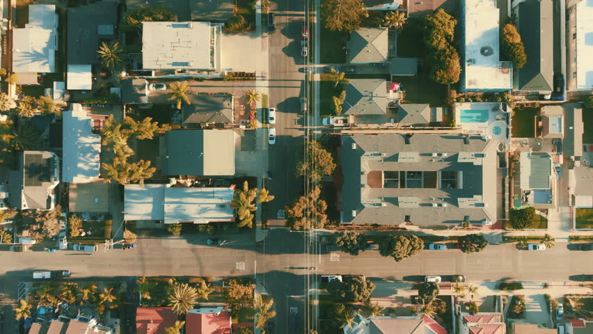 Aerial top view of Carlsbad homes and residential streets with palm trees and coastal California urban layout