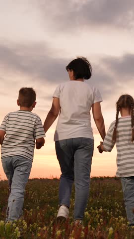 mother father children boy girl park sunset, man woman toddlers outdoors, Family walking in a field at sunset, happy family together outdoors, parents holding hands with children, family enjoying natu