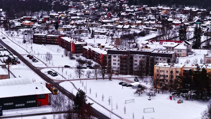 Winter town overview showing residential buildings and snow covering homes