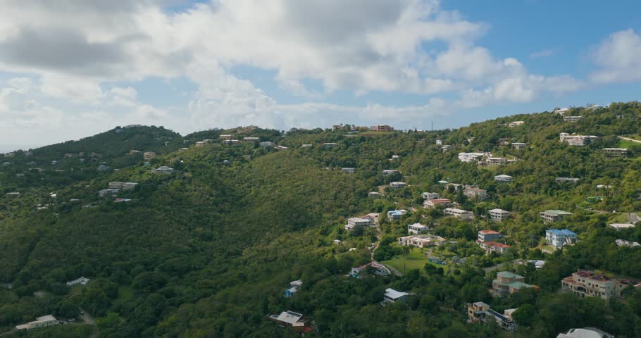 Residential Neighbourhood Over Dense Forest Hills On The Island Of St. Thomas In The U.S. Virgin Islands. Aerial Drone Shot