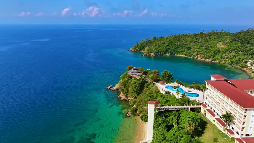 Aerial view of a beautiful coastal city with a resort area. Landscape of the Caribbean coast of Latin America. Summer seaside travel concept. High-rise apartments and hotels in the city.