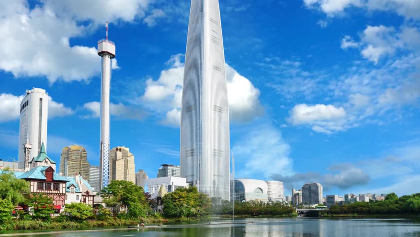 Wonderful view of park and skyscraper at downtown of Seoul, South Korea. Amazing modern tower is visible on blue sky background. Scenic cityscape. Seoul is a popular tourist destination of Asia.Seoul South Korea -Seoul South Korea - Circa Stunning wide angle time lapse of the Lotte world tower in downtown Seoul, South Korea.
