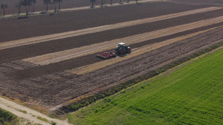 Tractor Plowing Agricultural Field in Italy