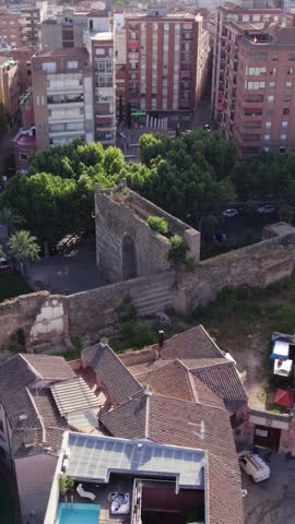 Vertical aerial orbit showcasing the historic Arab Walls located within Talavera de la Reina, Spain.