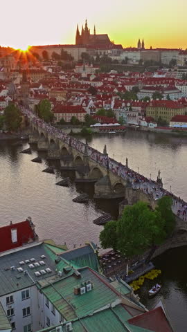  Aerial view of Prague Charles bridge and old town at sunset, over river. Czech Republic city Prague, city skyline 