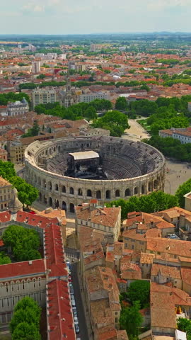  Aerial view of Nimes city with Roman amphitheater, travel in Nimes, France. Nimes Arena aerial panoramic view. Nimes is a city in the Occitanie region of southern France