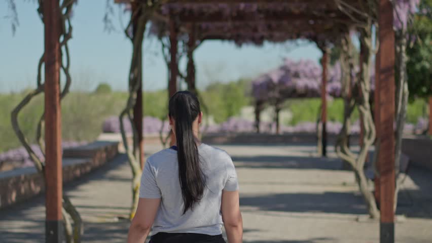 woman strolling through a scenic garden path