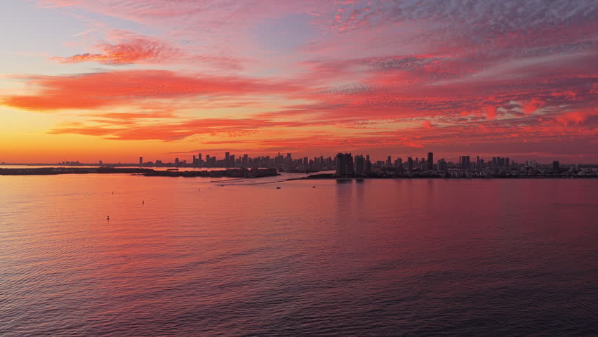 City skyline view. Sunrise cityscape, Florida. Sunset dramatic sky Miami city. Seascape with cityscape on sunset. Night cityscape of Miami with sea and dramatic sky. Miami sunset aerial sea.
