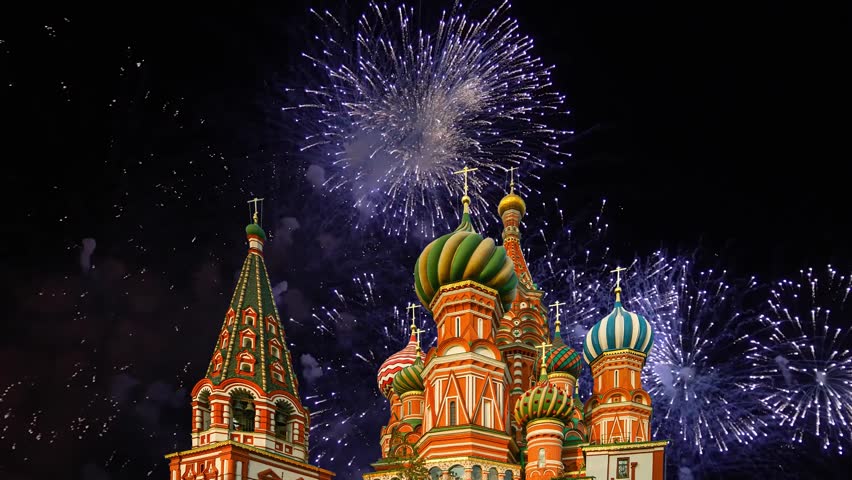 Temple of Basil the Blessed and fireworks in honor of Victory Day celebration (WWII), Red Square, Moscow, Russia. Time lapse, with zoom  