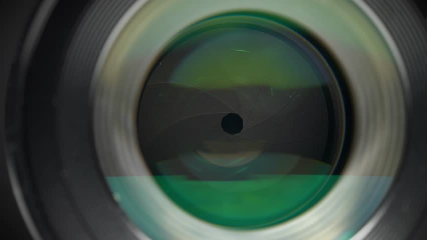 Close up macro shot of portrait lens showing aperture and diaphragm blades in sharp detail. Macro video of a camera lens highlighting the aperture mechanism and diaphragm blades from close perspective