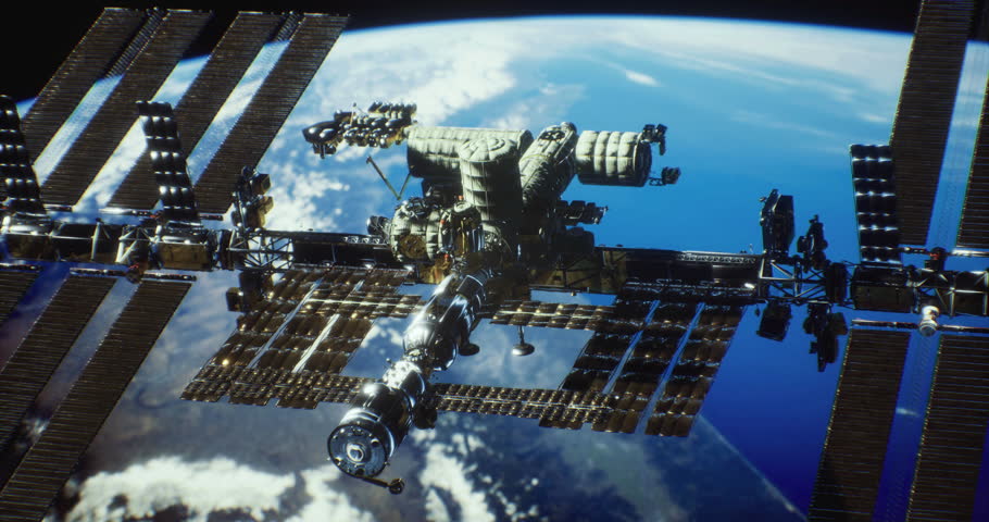 The International Space Station floats majestically above Earth, showcasing its intricate design against a backdrop of clouds and blue oceans. Sunlight glimmers on its surface.