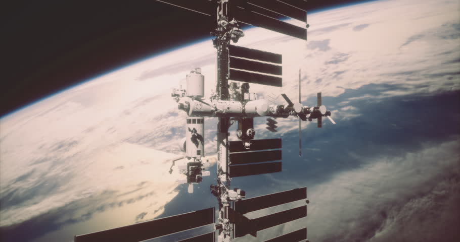 The International Space Station floats above Earth, showcasing its intricate structure against a backdrop of clouds and blue oceans. This view highlights space exploration efforts.