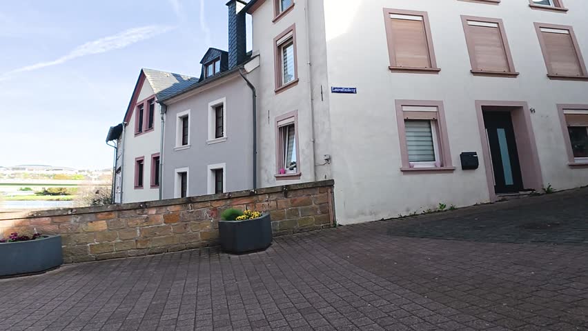 First person view of taking photo with camera in quiet residential European street