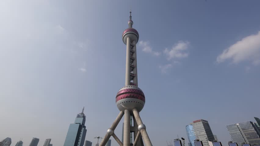 Pearl Tower Shanghai. Timelapse video of Shanghai iconic Oriental Pearl Tower in Lujiazui Pudong China with city lights moving cloud and urban traffic. Travel tourism and landmark city skyline concept