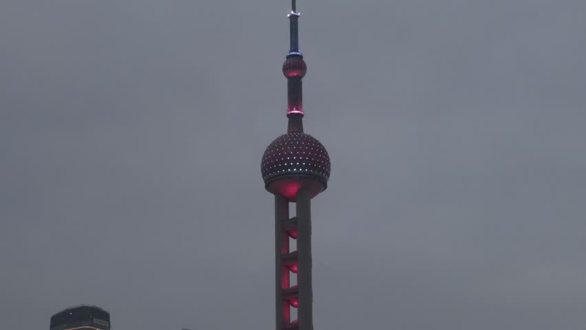 Pearl Tower Shanghai. Timelapse video of Shanghai iconic Oriental Pearl Tower in Lujiazui Pudong China with city lights moving cloud and urban traffic. Travel tourism and landmark city skyline concept