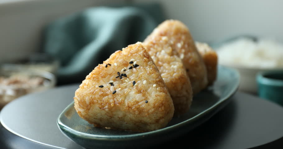 Delicious Yaki Onigiri (grilled rice balls) on table, rotating