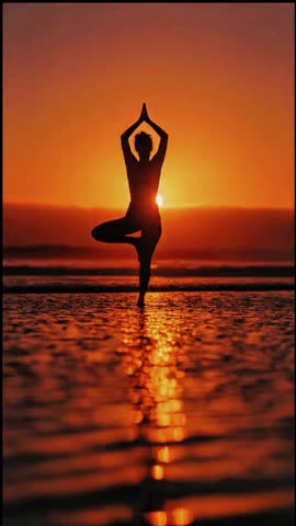 Stock video showing the silhouette of a woman doing various yoga poses on the beach at sunset with dramatic orange lighting.
