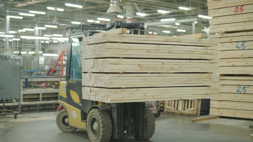 Close-up of an automated production line with timber slats in motion within a modern wood processing facility