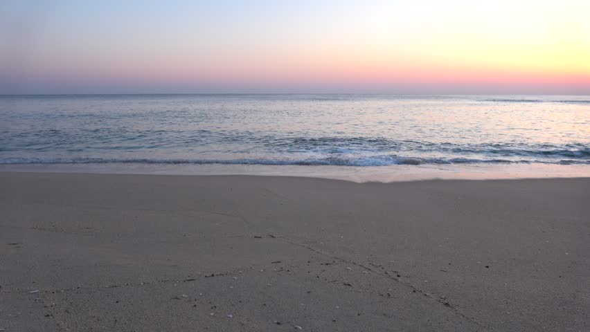 4K ASMR Early Dawn Beach Horizon: Soft Pink Sky and Gentle Waves with Authentic Ocean Sound.
A serene 60-second long take of a coastal dawn captured with a manual focus set to 1.5  meters for a natural, soft depth on April 8, 2026. The scene features a 2:2:6 ratio of sky, sea, and beach, divided by a crisp horizontal line. The sky transitions beautifully from pale gold to soft pink and light purple, reflecting brilliantly onto the calm, pink-hued ocean. In the foreground, a dark brown sandy beach reveals delicate seashells and rhythmic water marks left by the tide. This high-resolution 4K footage includes authentic, soothing ambient audio of gentle wind and soft waves, creating a perfect ASMR experience.