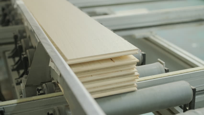 Close-up of an automated production line with timber slats in motion within a modern wood processing facility