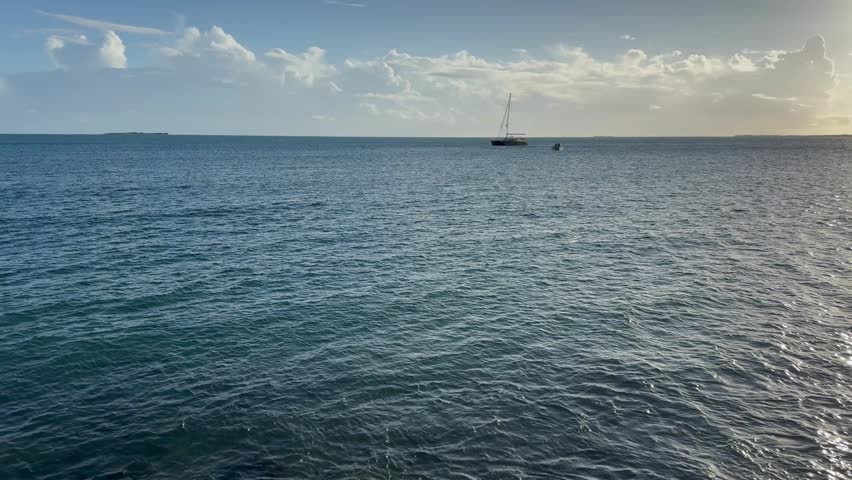 Cinematic 4K wide shot of the tropical Caribbean coastline in Puerto Rico, featuring the blue ocean horizon, rocky shores, and scenic coastal views under a clear bright sky.