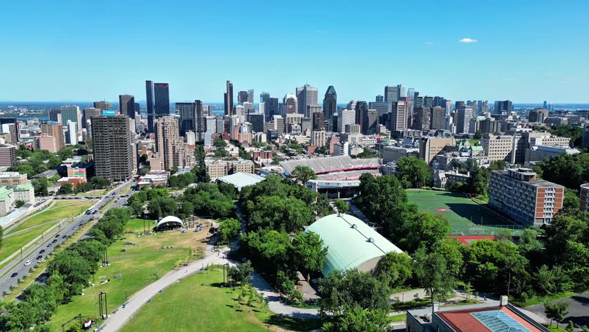 4K aerial drone footage of Montreal skyline in Quebec, Canada. Cinematic cityscape featuring modern skyscrapers, urban architecture, and downtown city view.