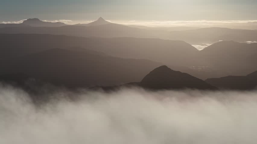 Sunrise and Cloud Inversion Rolling Fog above Mount Murchison, Tullah, Tasmania Aerial Drone 4K