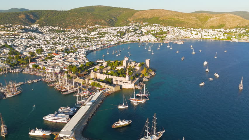 Bodrum, Turkey. Aerial drone panorama of Bodrum Castle dominating coastline with yachts in bay, beaches and white houses scattered on hills. Aerial View, MasterShots, Circle (Far)
